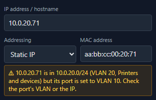 A NetLay warning saying an address belongs to one VLAN's subnet while its port is set to a different VLAN, suggesting you check the port or the IP.
